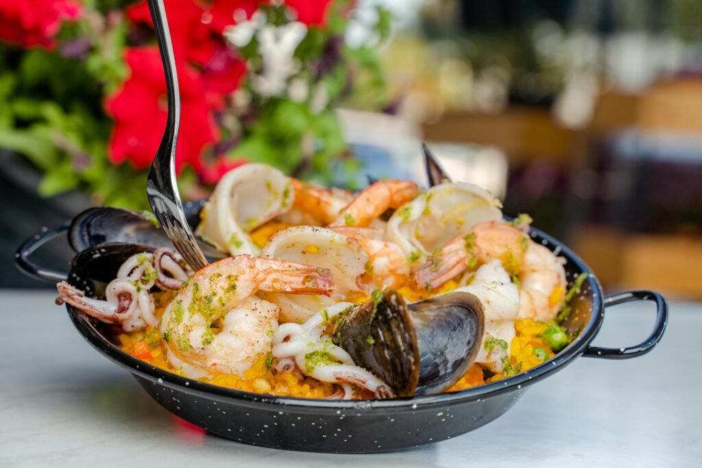 Mediterranean Paella with chicken, shrimp, mussels, and saffron rice.